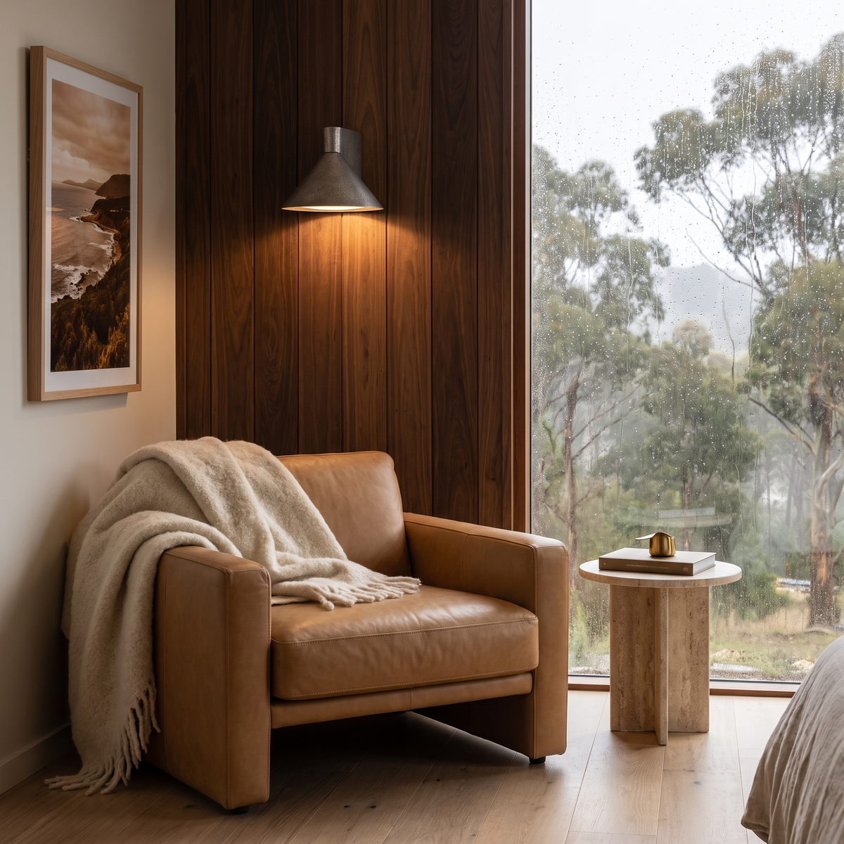 Kula cone wall light above a leather armchair in a Tasmanian reading nook