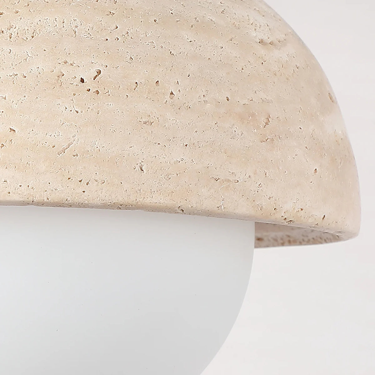 Lido travertine swing arm wall lamp close-up of the travertine dome shade and opal globe