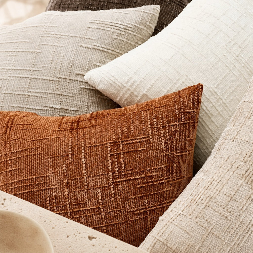 Close-up of the Lucina chenille throw pillow in brown red showing its bamboo-textured weave