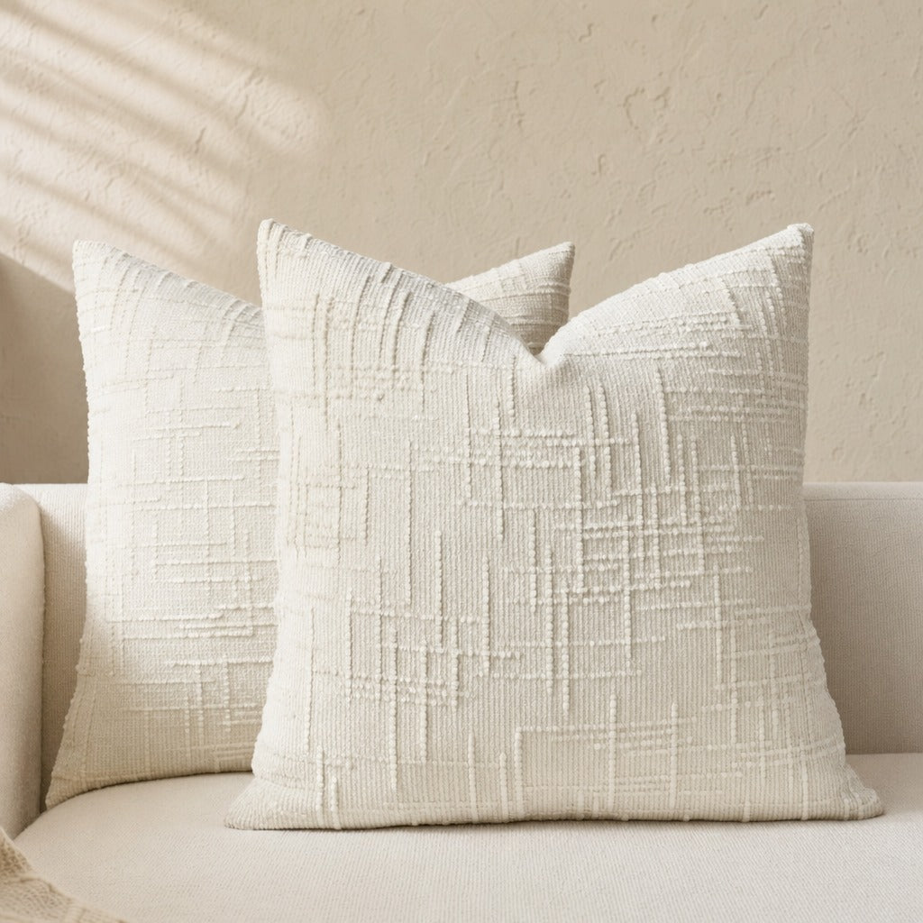 Lucina chenille throw pillows in cream with a bamboo-textured weave on a white sofa