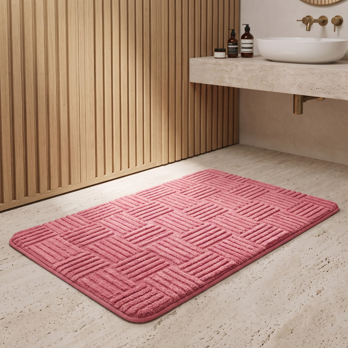 Marden striped non-slip bath mat in pink red on a travertine floor by timber wall panelling