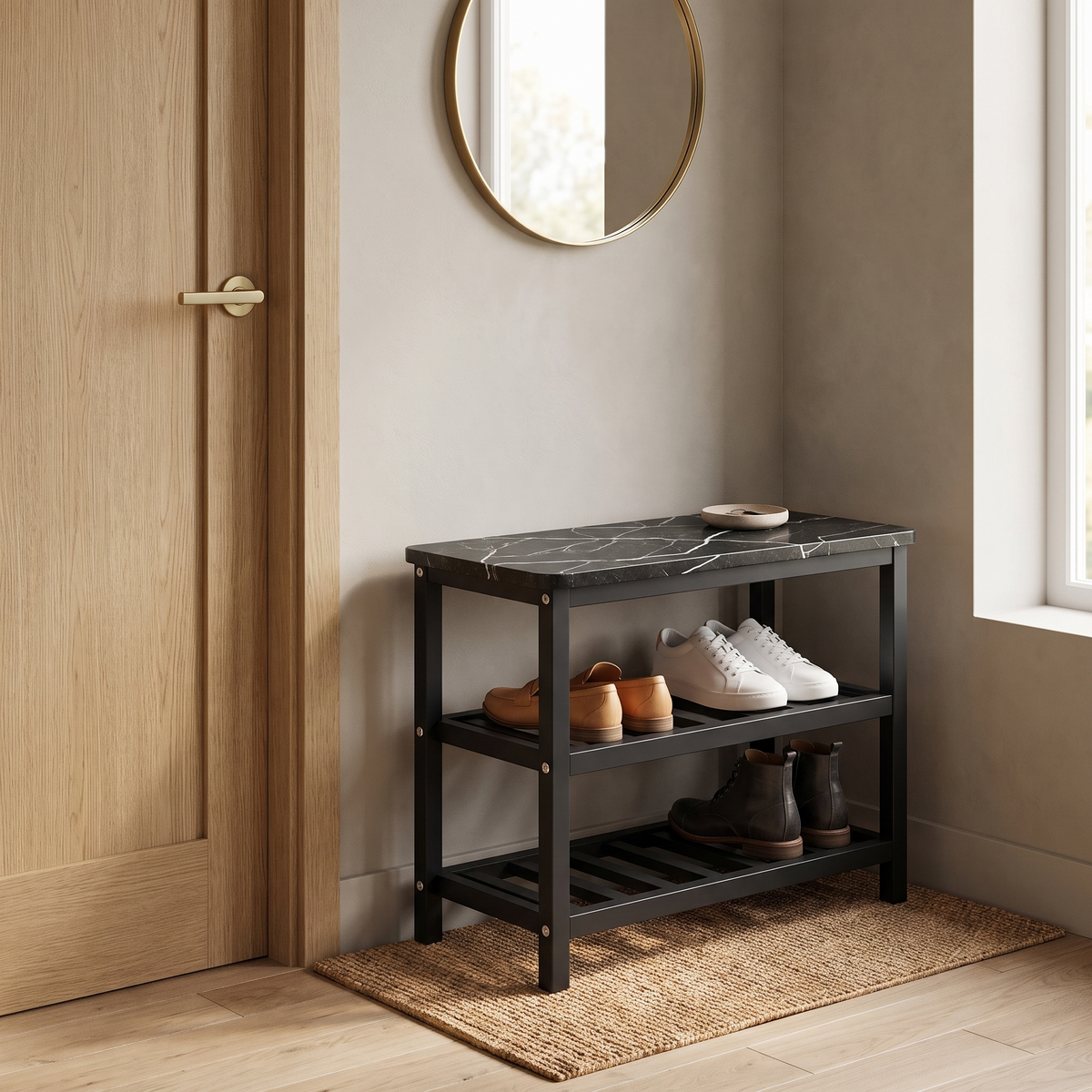 Mata shoe rack with black marble-look top beside a light oak front door under a round brass mirror