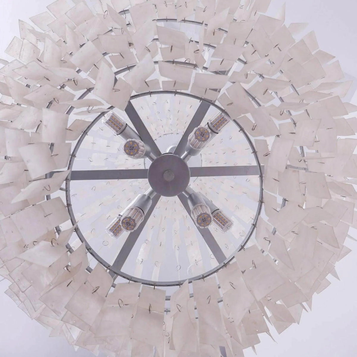 Underside of the Maui chandelier showing the eight E14 lamp holders on the chrome spoke frame