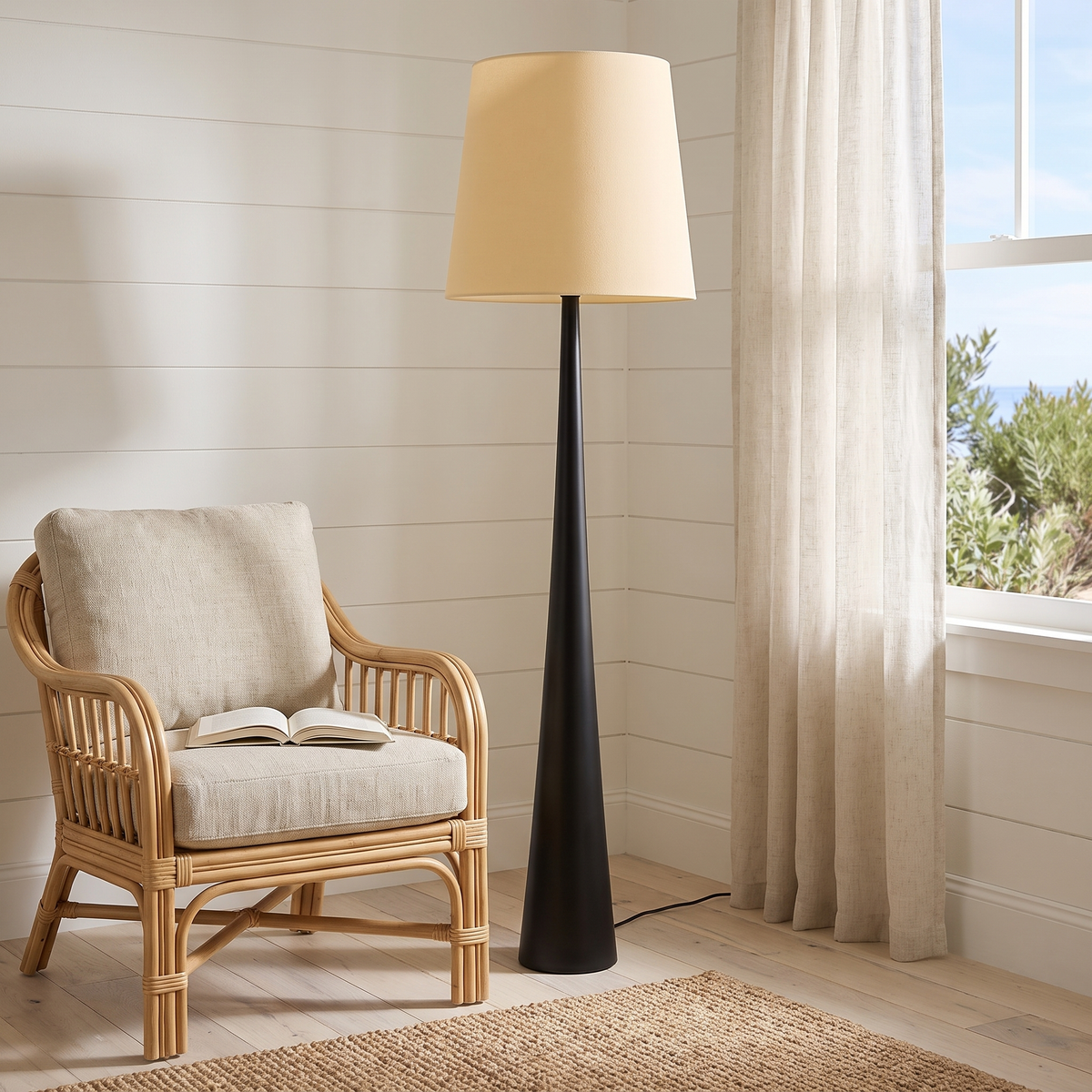 Moa Scandinavian Floor Lamp beside a rattan armchair in a coastal reading corner
