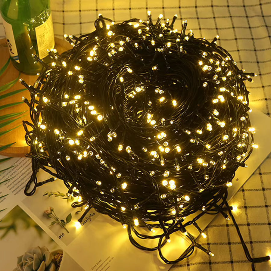 Mulligan warm white LED fairy lights piled on a checked picnic rug