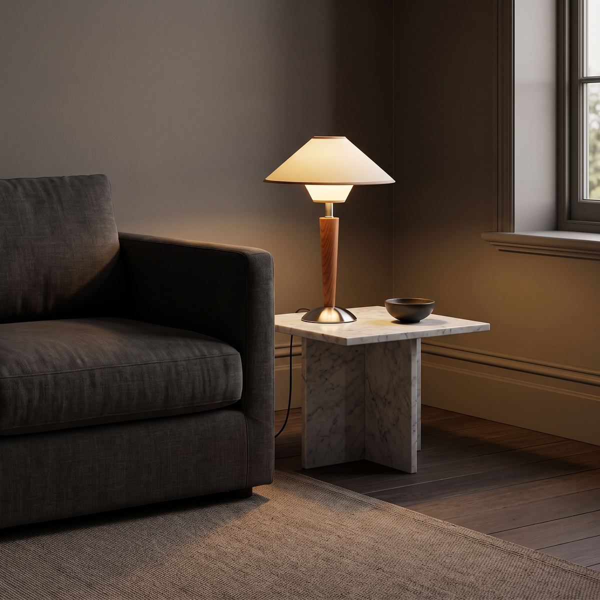 Nati Wooden Table Lamp in Cream lit on a marble side table beside a charcoal linen sofa