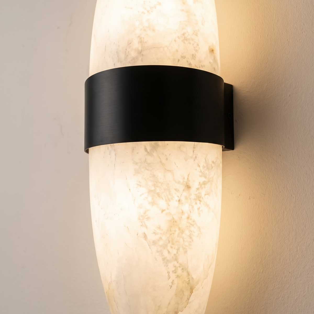 Close-up of Nula snowflake alabaster glowing with its black stainless steel band