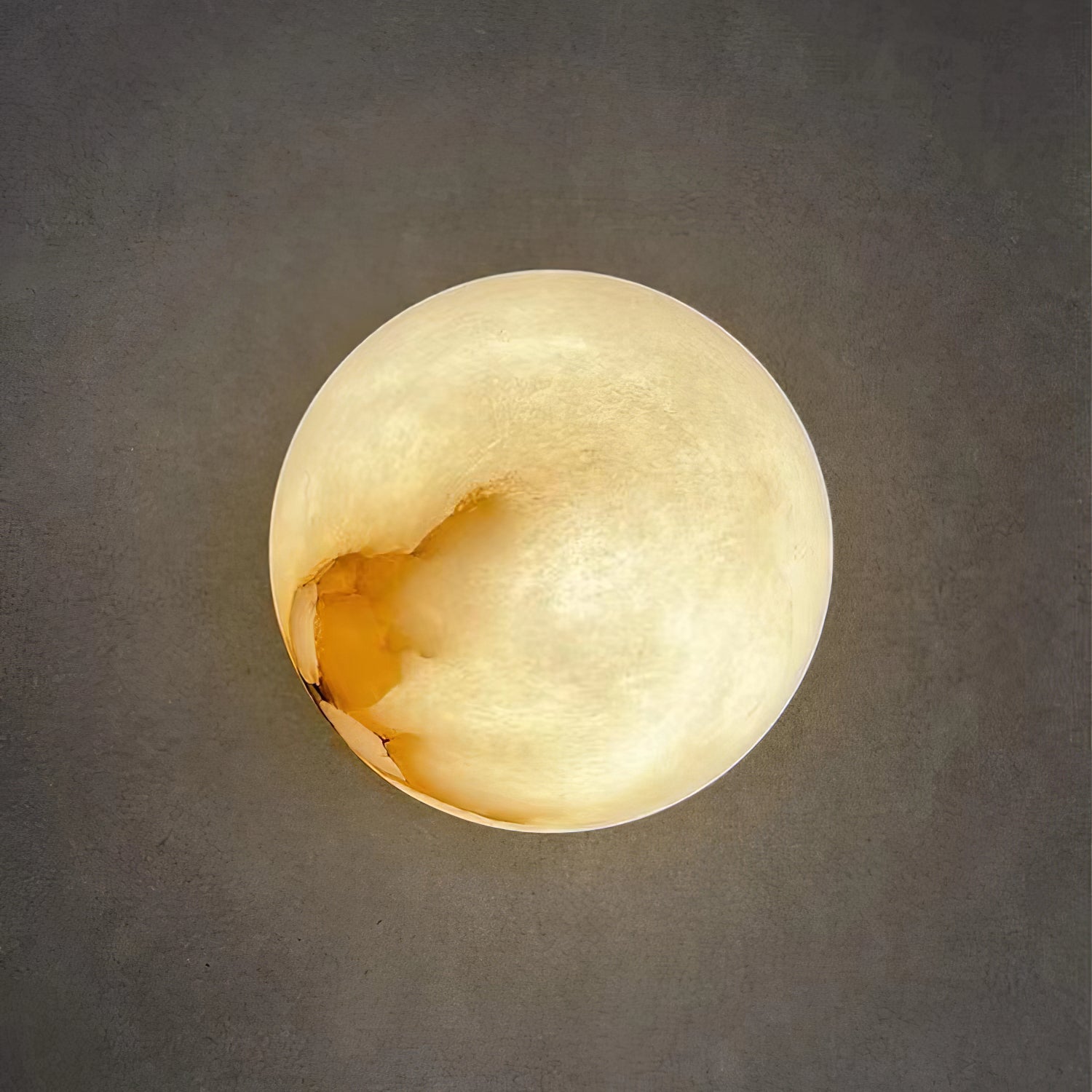 Orby alabaster wall lamp mounted on a wall as a bedside reading light