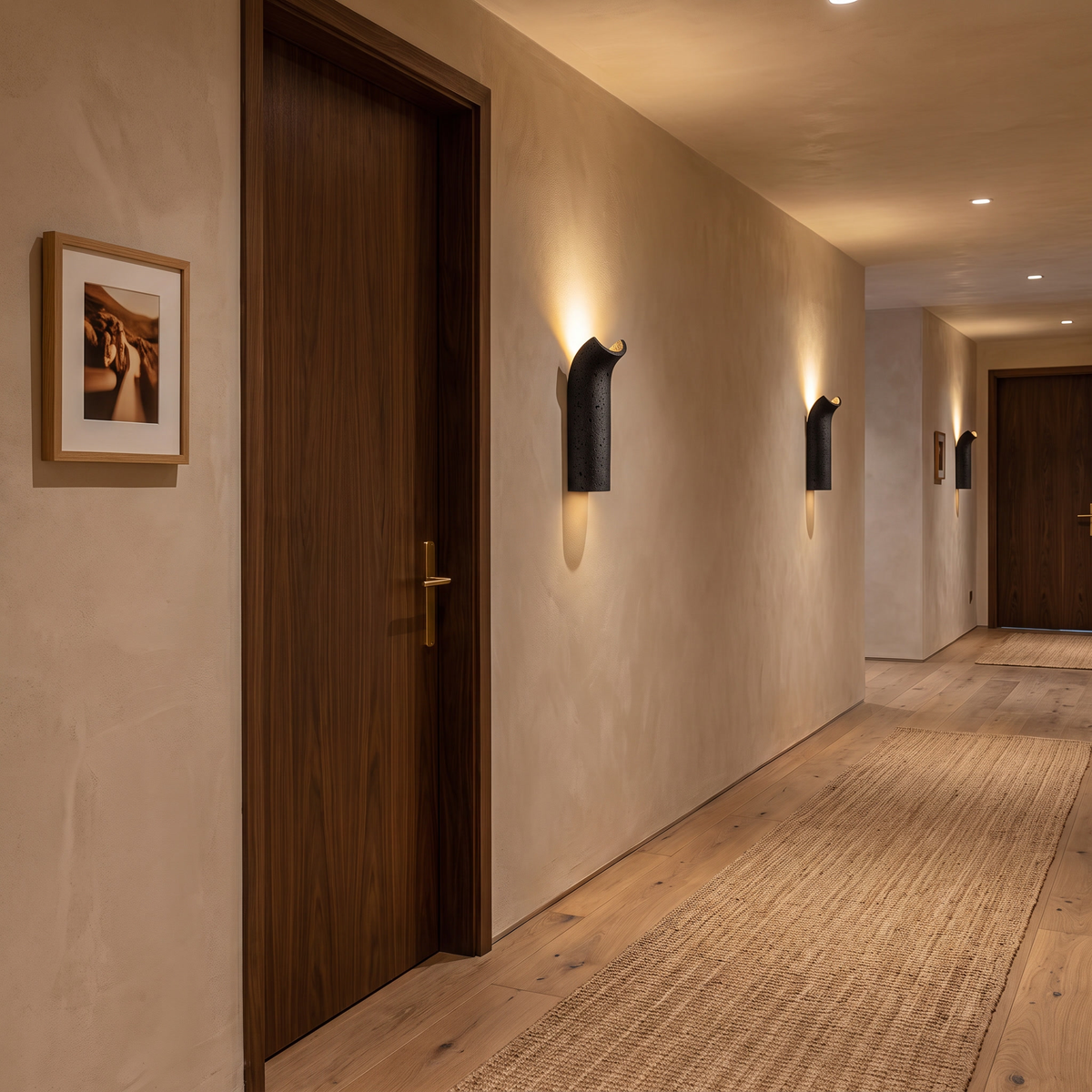 Pasa travertine wall lamp along a boutique hotel corridor with timber doors