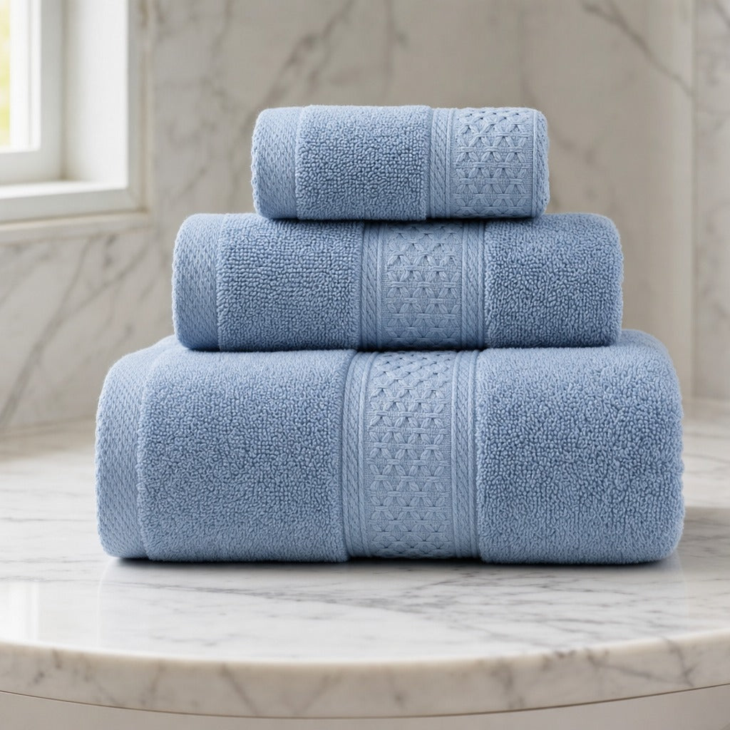 Serene 100% cotton bath towels in light blue stacked on a round marble vanity