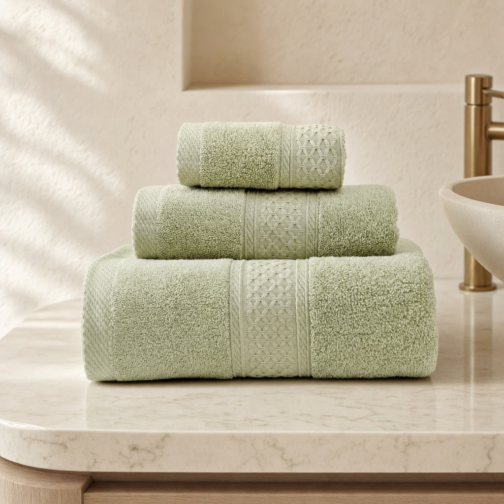 Serene cotton bath towel set in light green on a round marble bathroom vanity