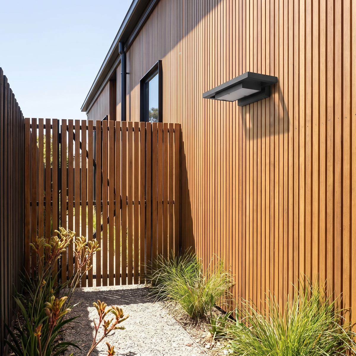 Shan outdoor wall light, 35cm, on blackbutt battens beside a slatted side gate at midday