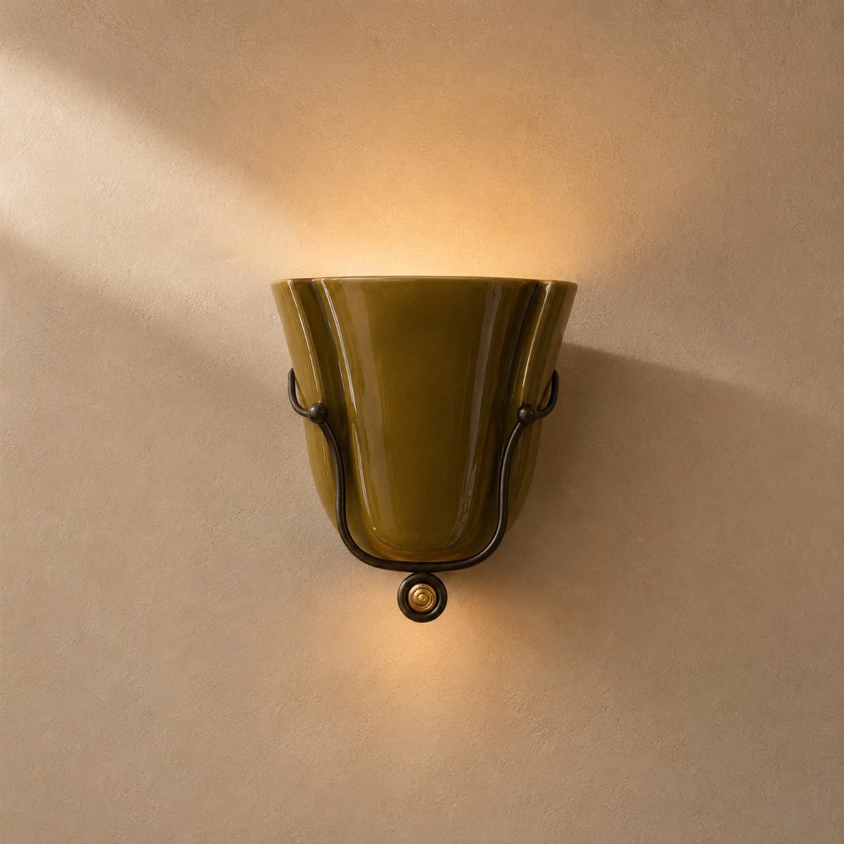 Smyth ceramic wall sconce in glossy brown-green glaze in a black forged cradle
