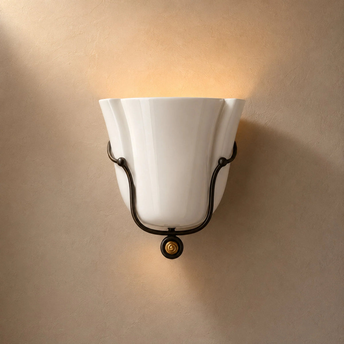 Smyth ceramic wall sconce in glossy white glaze washing light up the wall