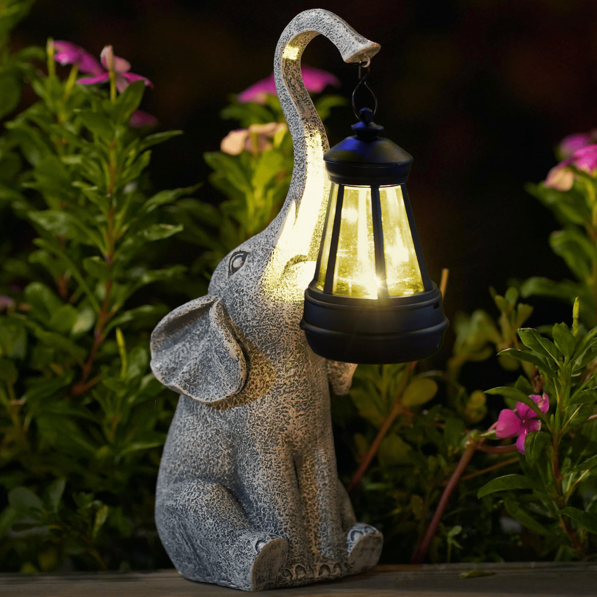 Solar Elephant Garden Light illuminated at dusk on a patio