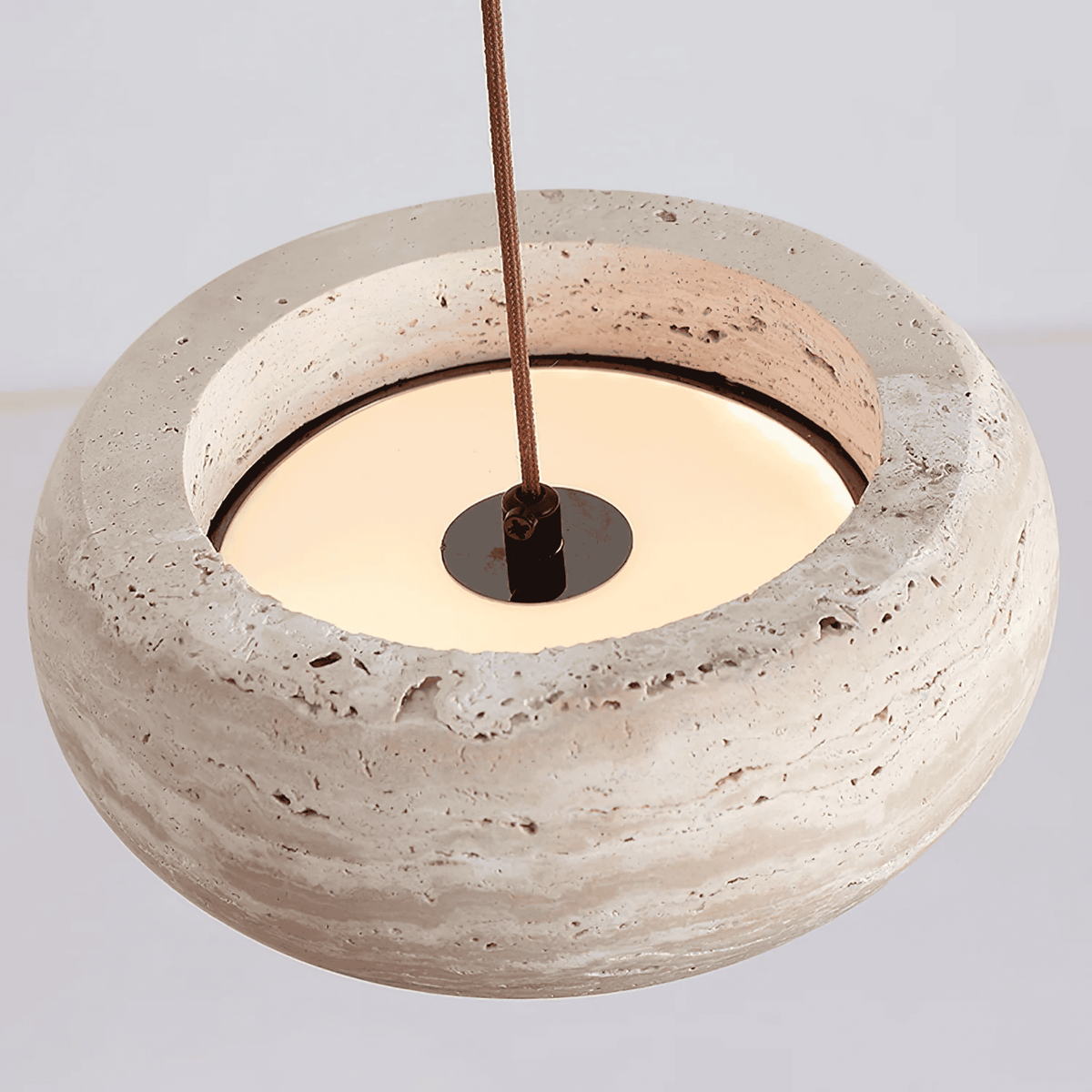 Top view of Sora rounded edge travertine pendant light showing cord fitting and LED diffuser
