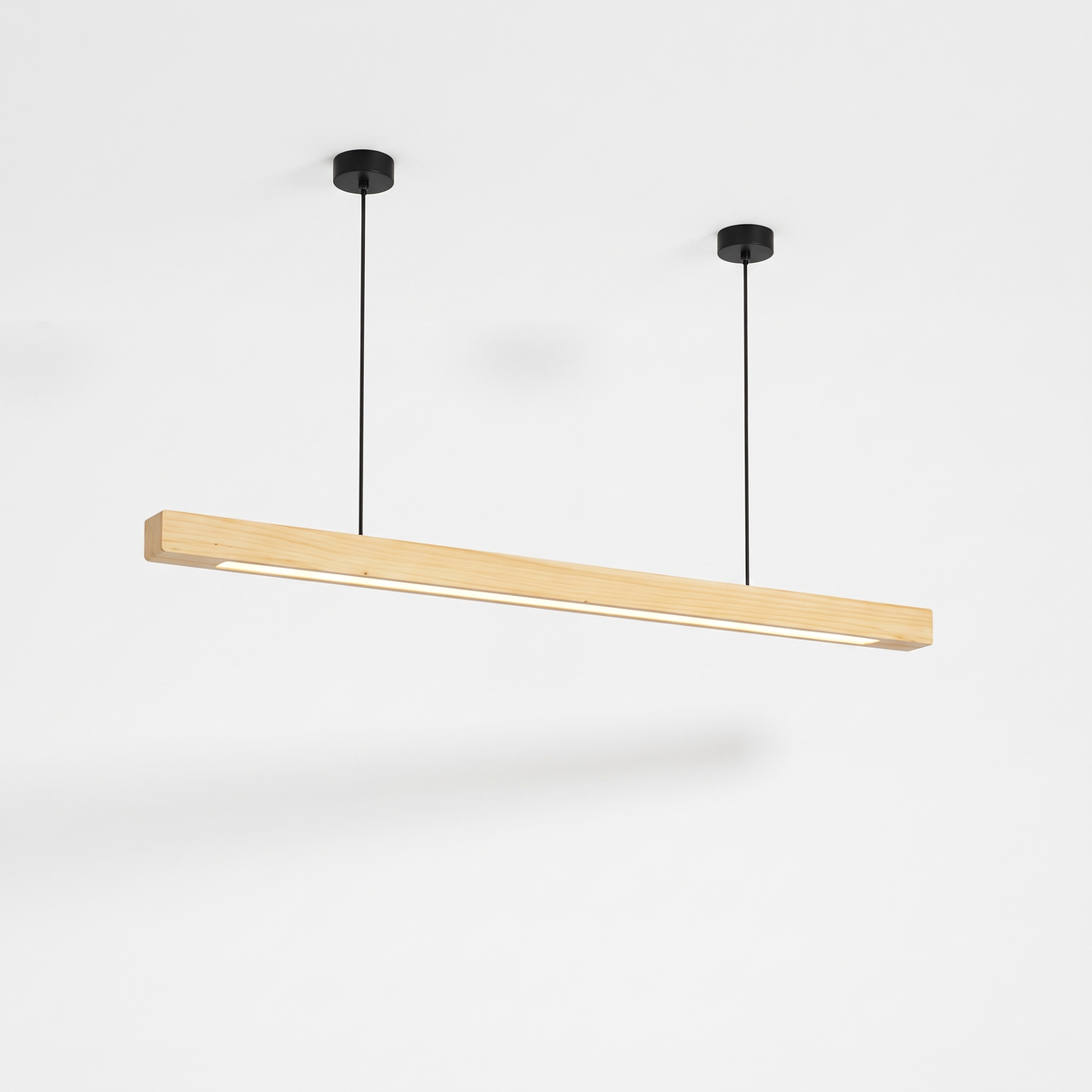 Sorrento linear timber pendant light in Pine A on cables, glowing underside, on a white background