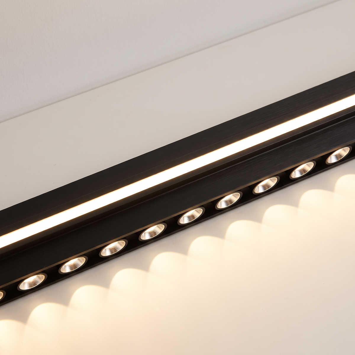 Close detail of the Spice pendant showing the frosted LED strip and the row of recessed downlight eyes