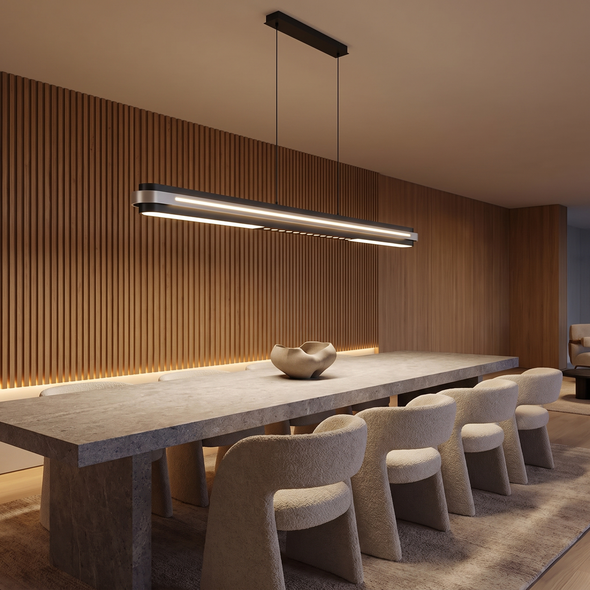 Spice linear LED pendant light over a long stone dining table with a fluted timber feature wall