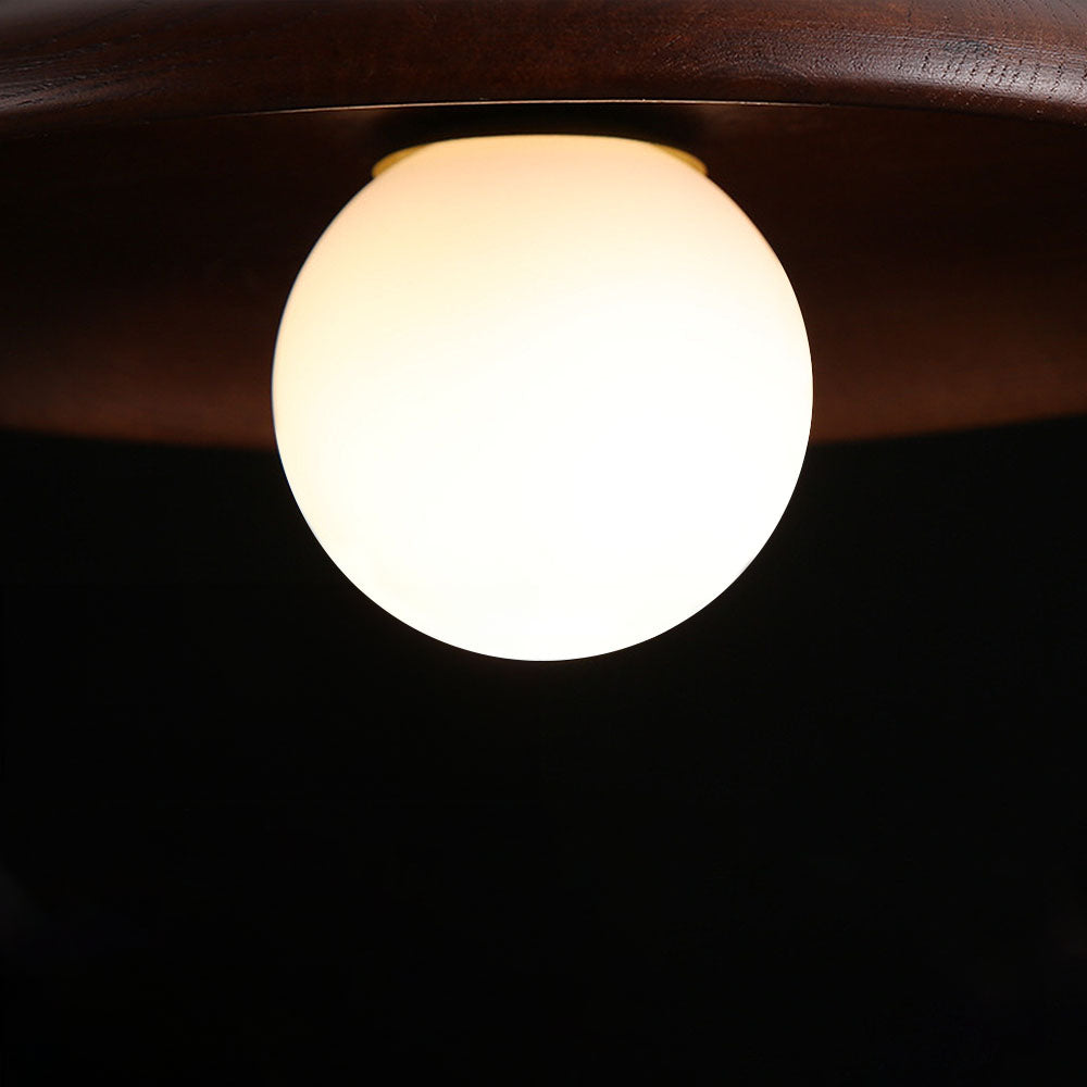 Detail of the Suma timber ceiling light showing the turned timber saucer shade and opal glass globe