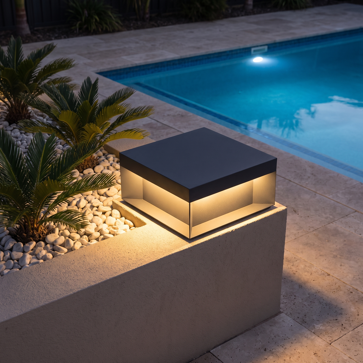 Summer 15.5cm solar garden light on a planter wall beside a pool
