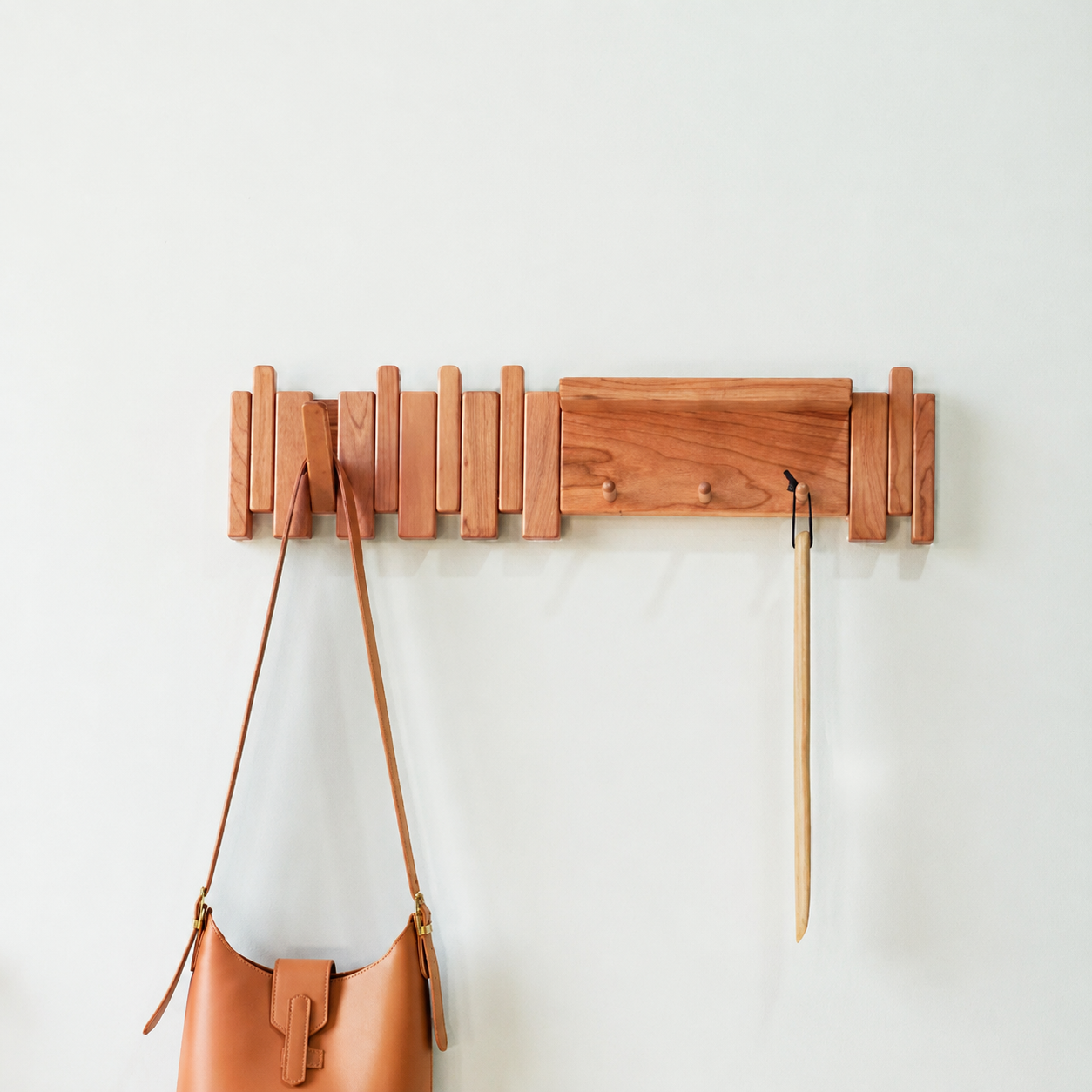 Tal Wooden Coat Rack in its piano key-inspired design and an alternate wood finish