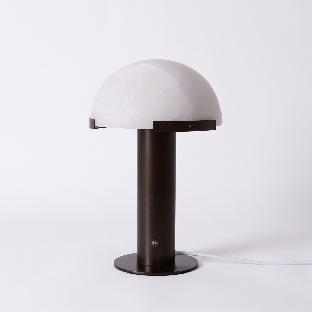 Taya alabaster table lamp with black bronze base on a white background
