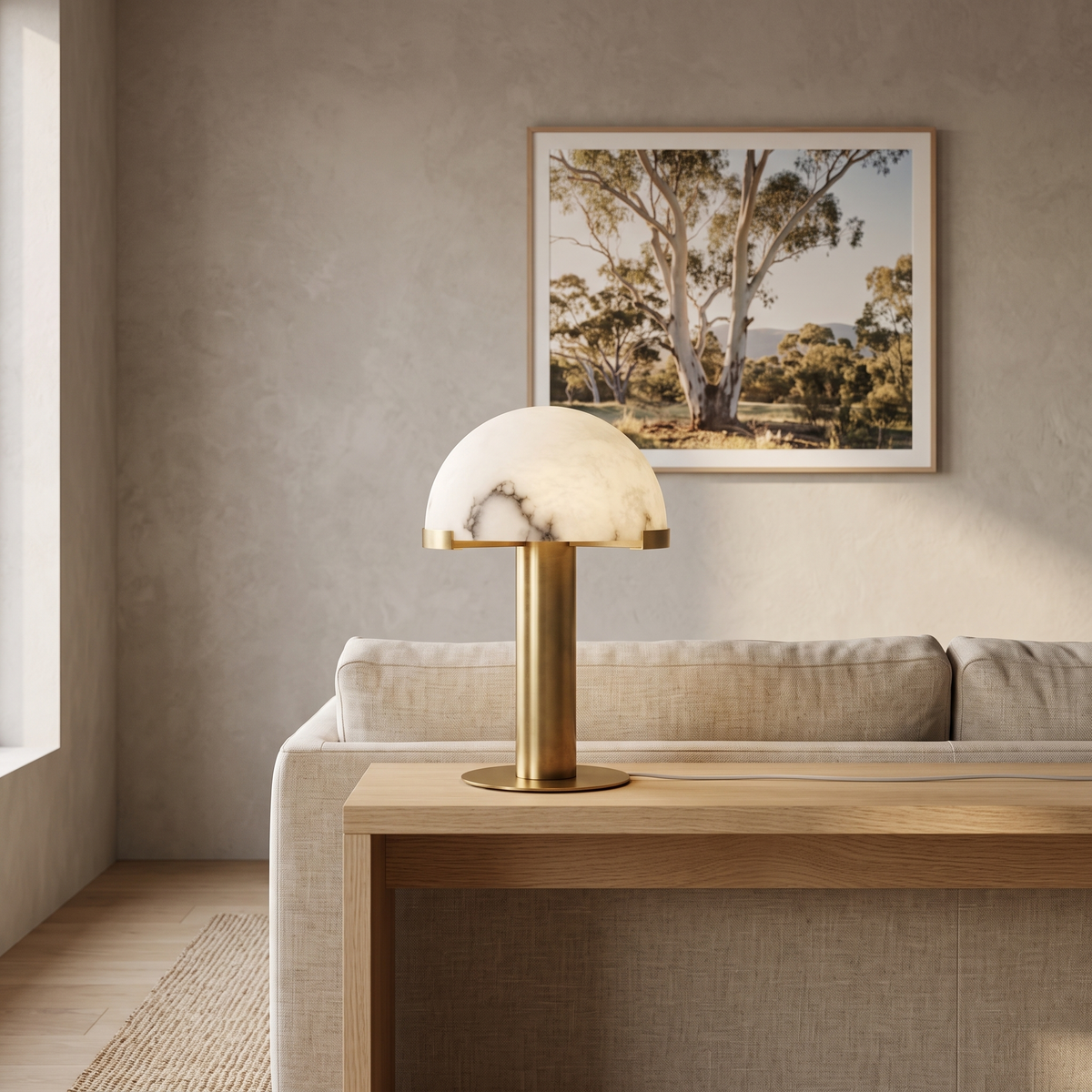 Taya alabaster table lamp with gold bronze base on an oak console in a Japandi living room