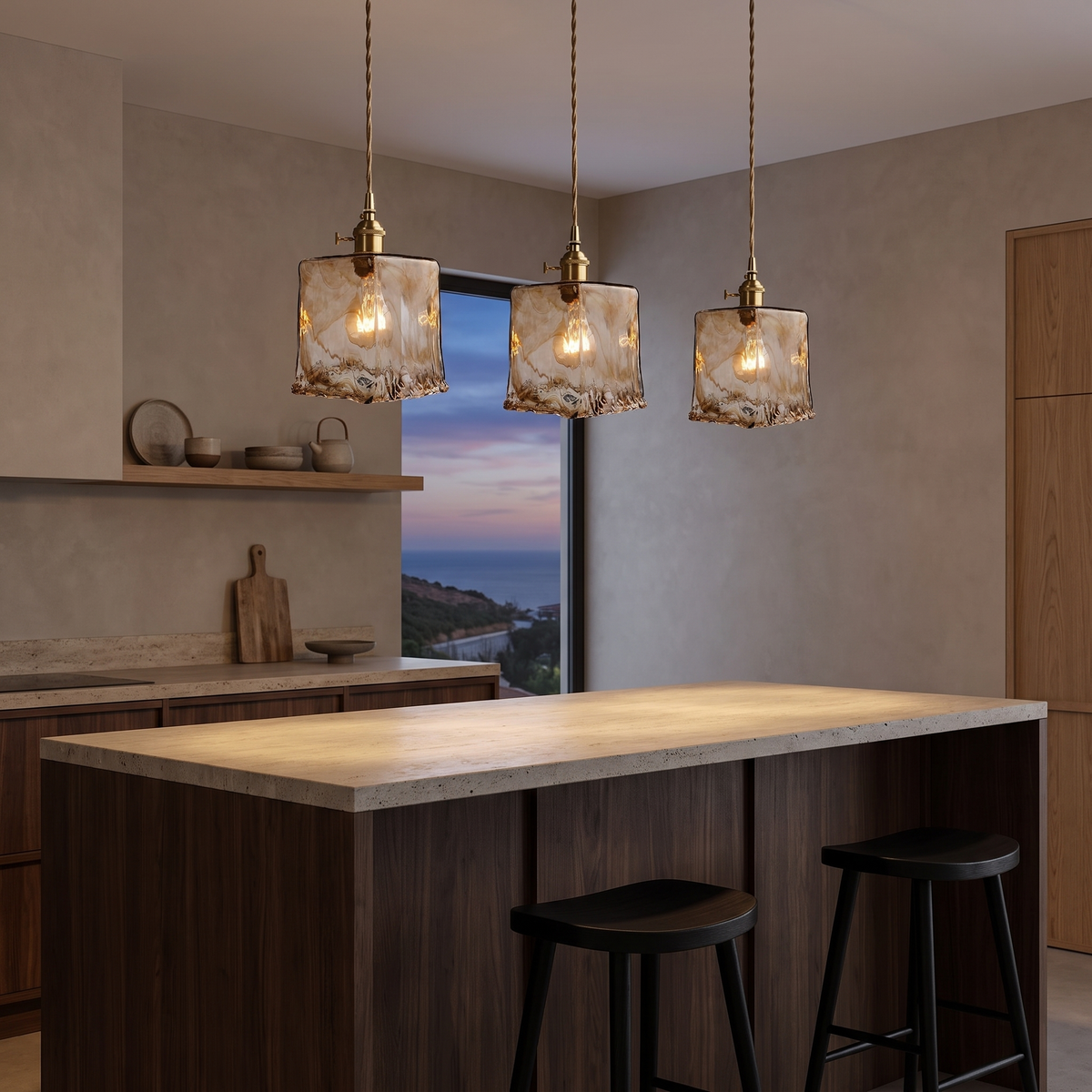 Three Tooky Model C amber glass pendants glowing over a walnut kitchen island at dusk