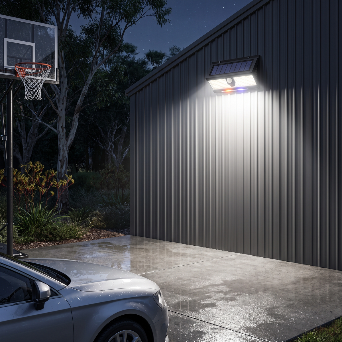 Vela solar motion sensor security light on a garage wall lighting a driveway