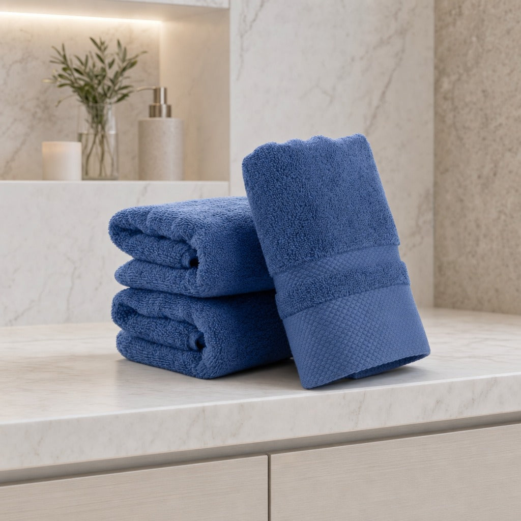 Velour striped 3-piece bath towel set in dark blue on a white marble vanity with greenery