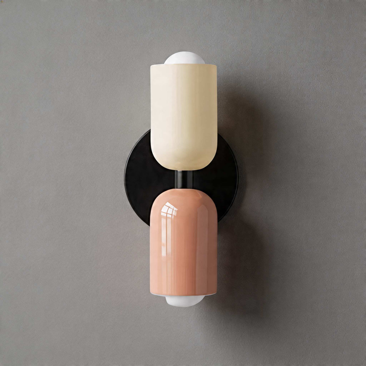 Vic Nordic up down wall sconce with a black wall plate, white upper shade and pink lower shade