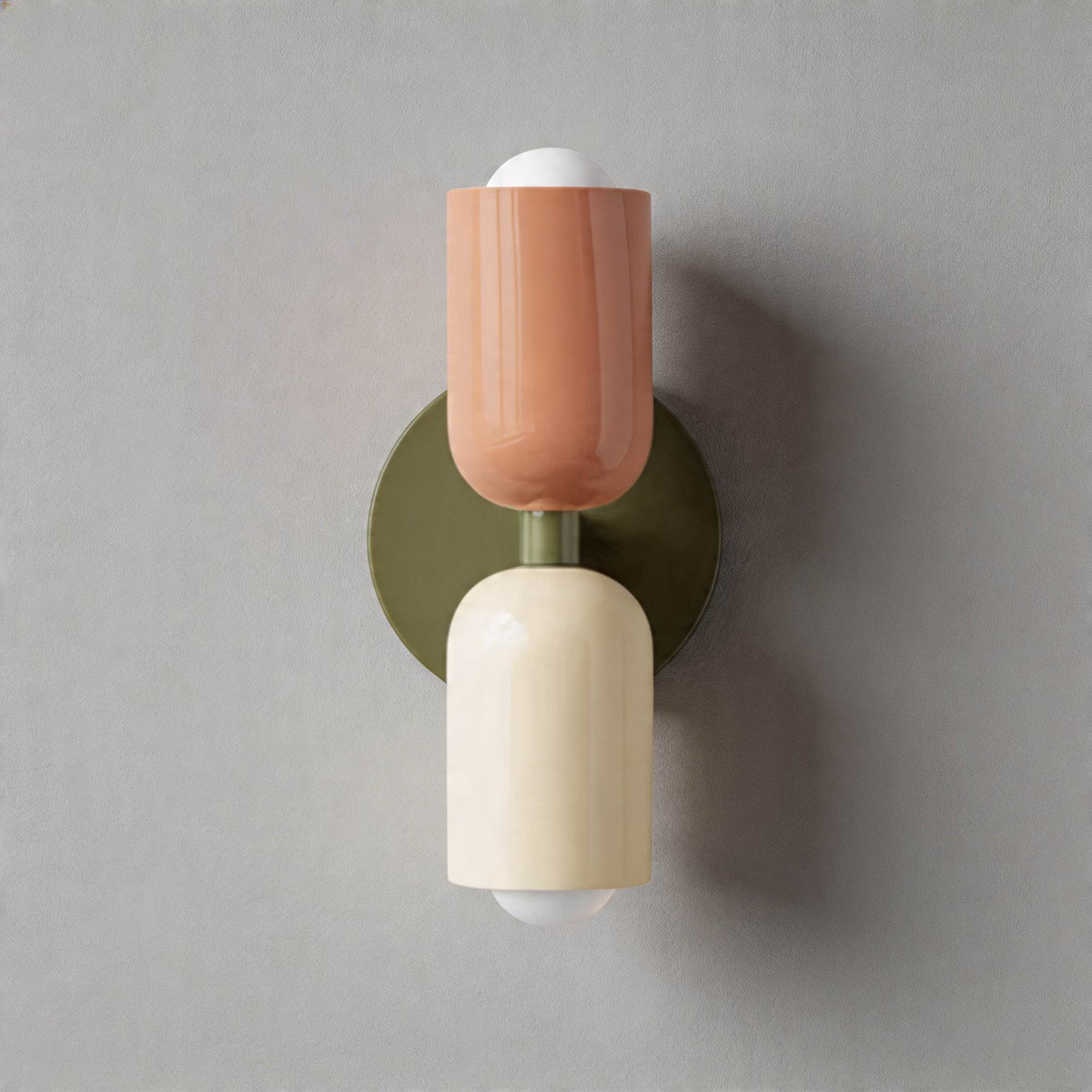 Vic Nordic up down wall sconce with a green wall plate, pink upper shade and white lower shade