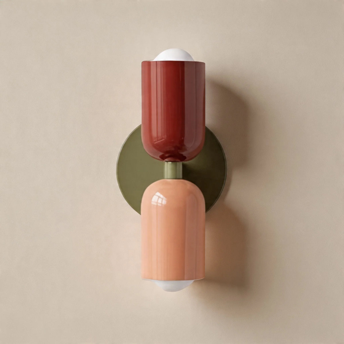 Vic Nordic up down wall sconce with a green wall plate, red upper shade and pink lower shade