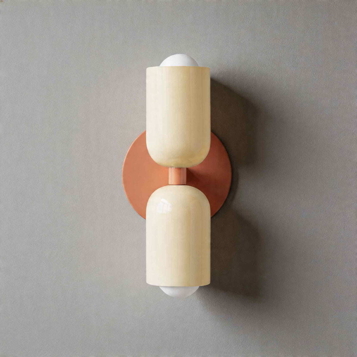 Vic Nordic up down wall sconce with a pink wall plate and two white painted iron shades