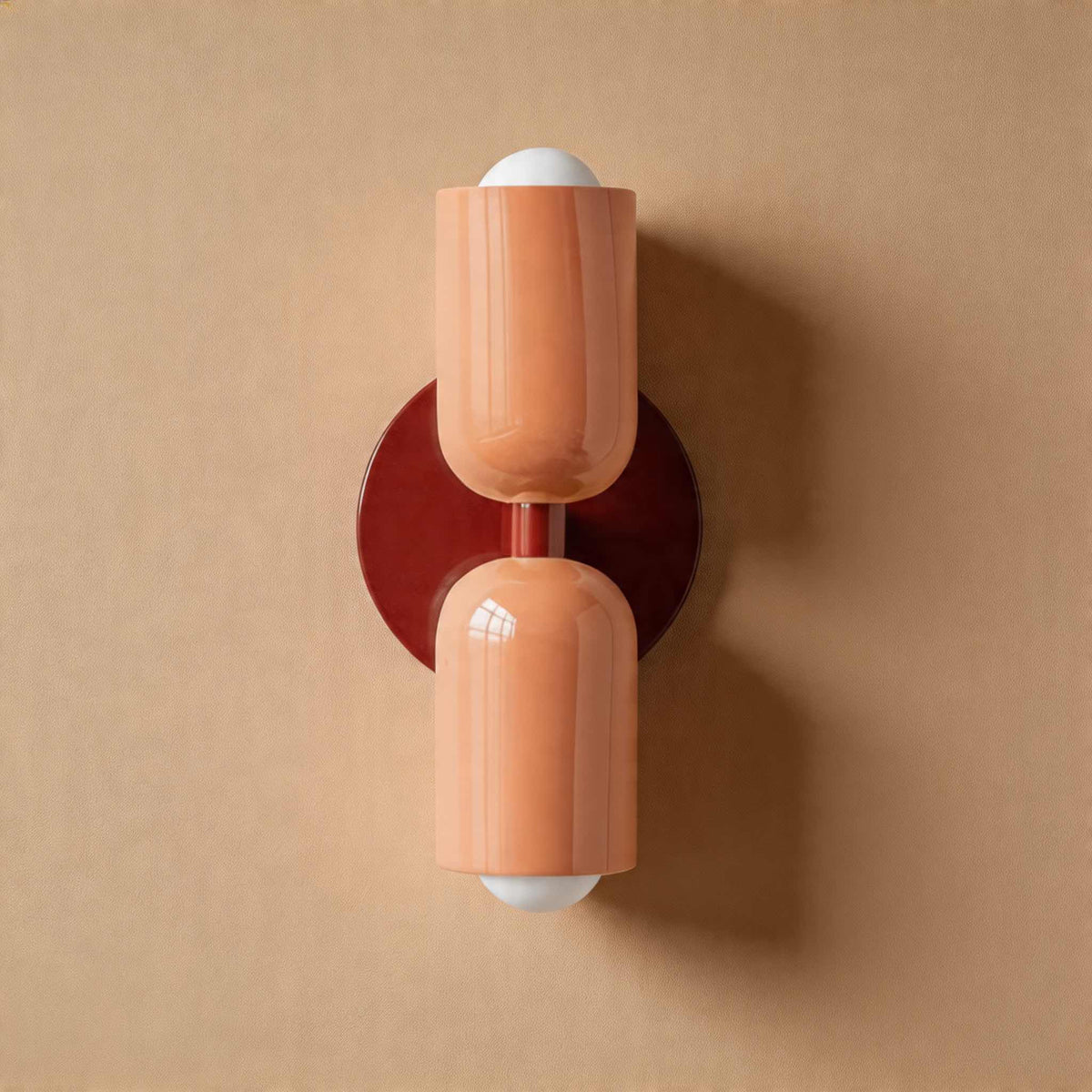 Vic Nordic up down wall sconce with a red wall plate and two pink painted iron shades