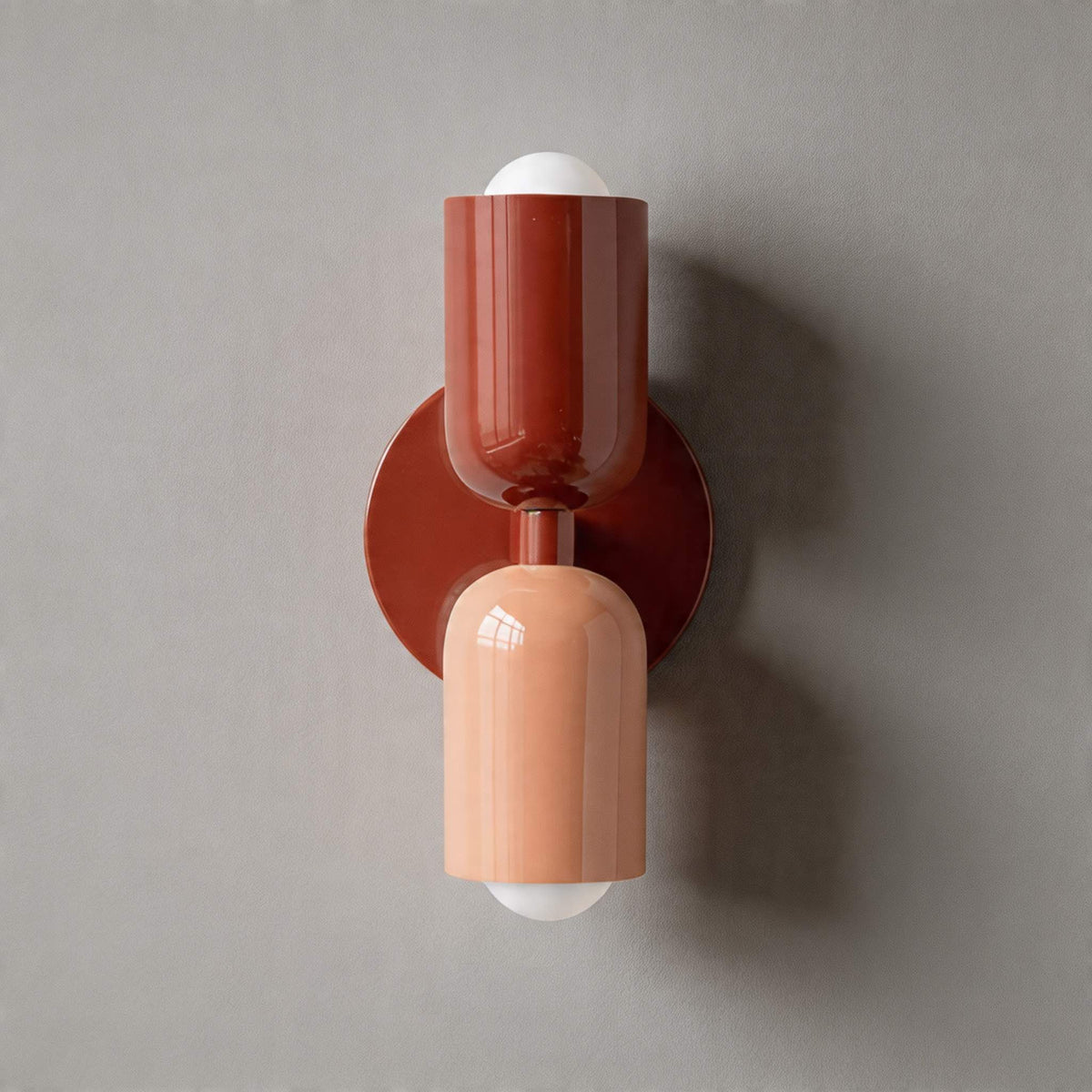 Vic Nordic up down wall sconce with a red wall plate, red upper shade and pink lower shade