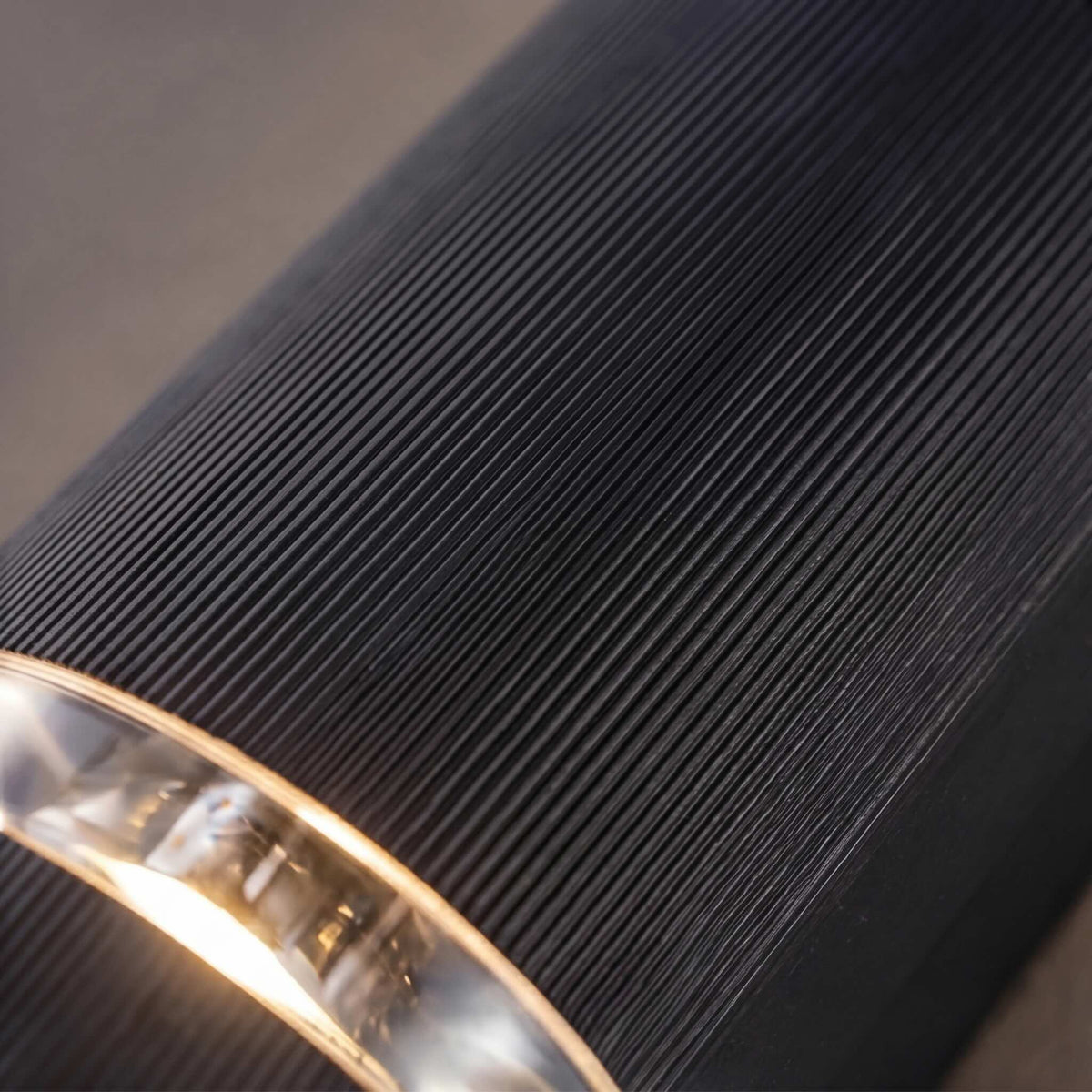 Close-up of the Visage up down wall light ribbed black aluminium body and clear lens ring