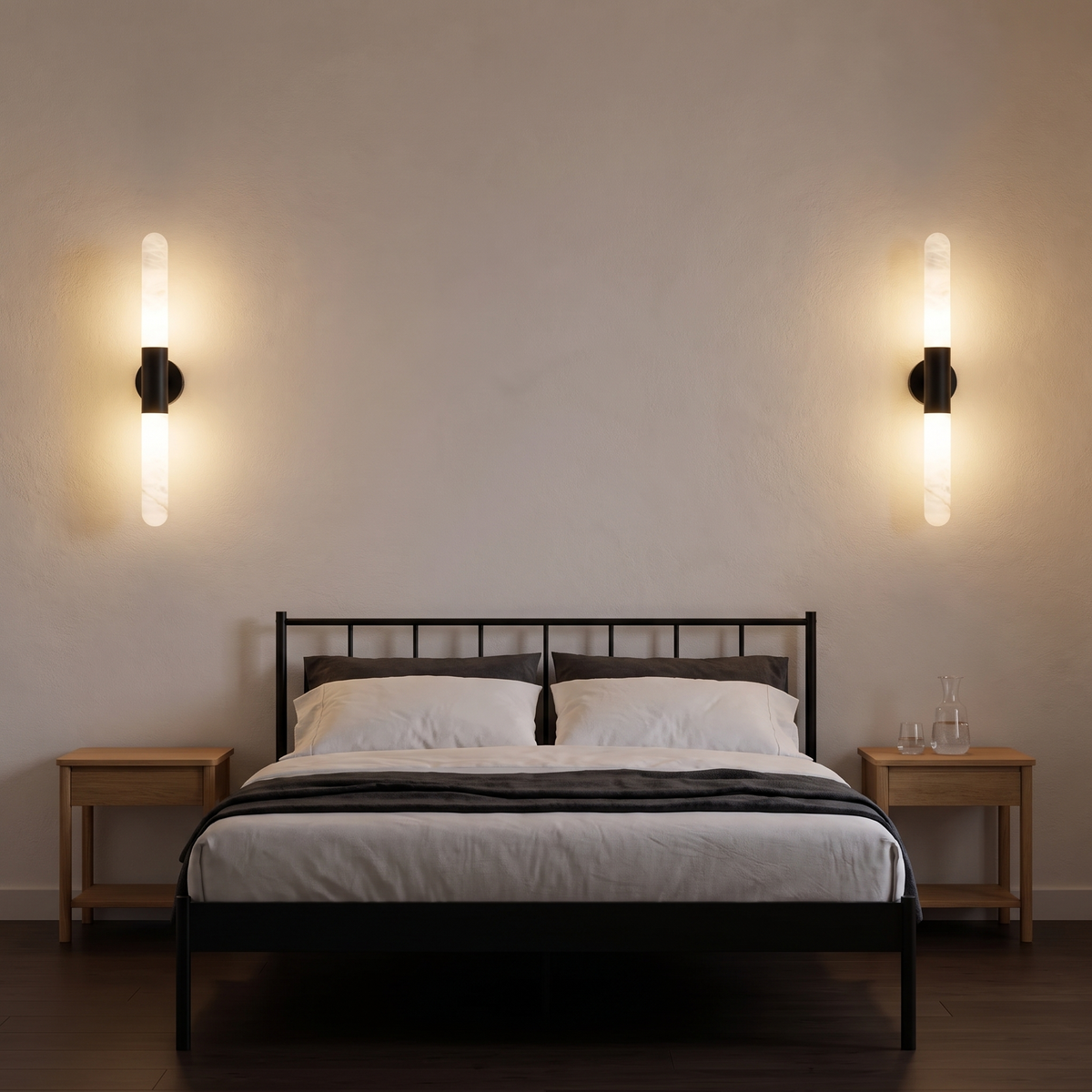 Pair of Waverly black alabaster wall lights either side of a black metal bed