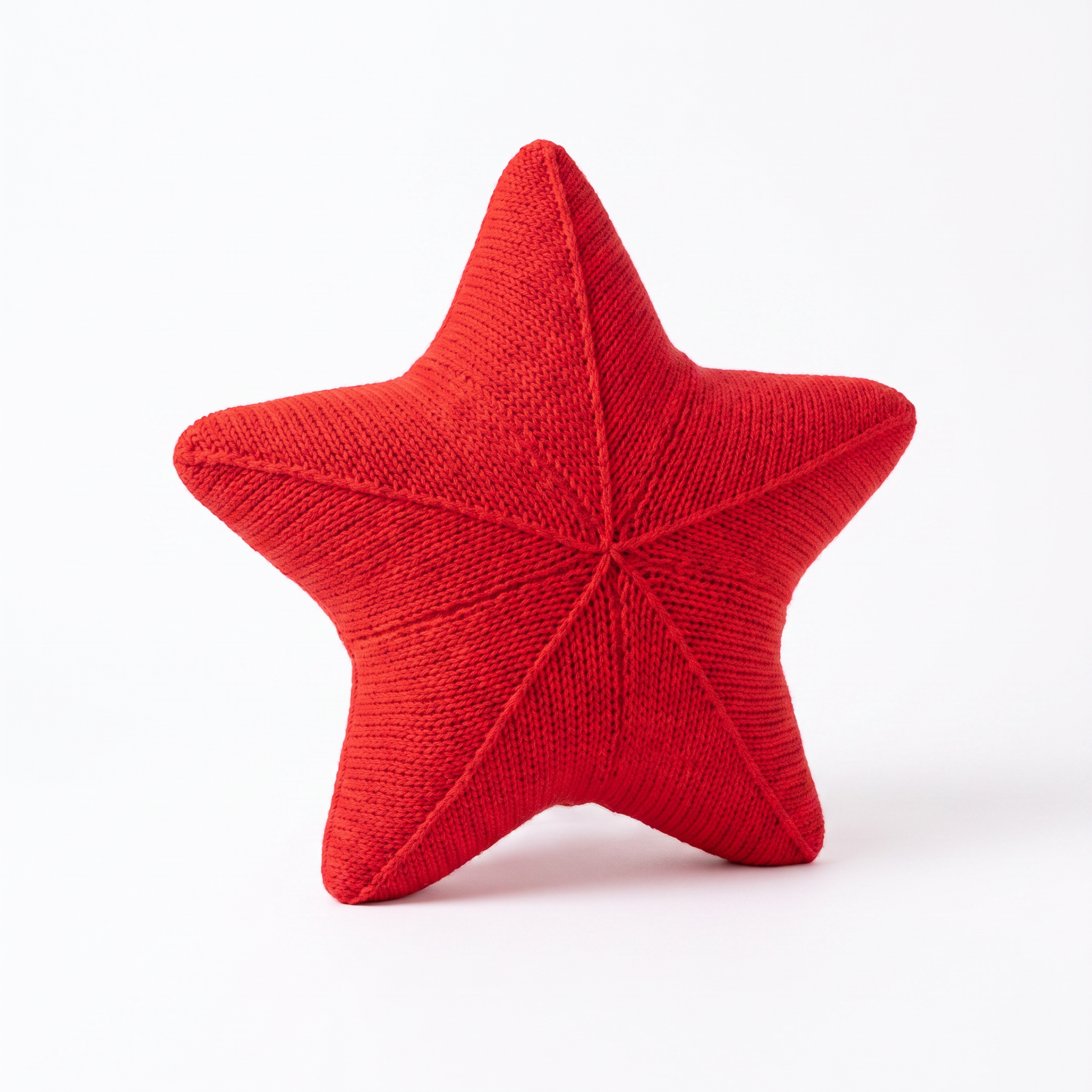 Zoe hand-knitted starfish cushion in Sunset Wave on a white background
