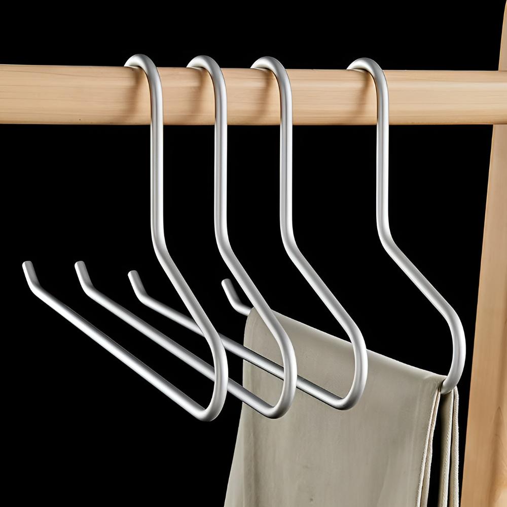 Set of metal hangers on a wooden rod with a black background