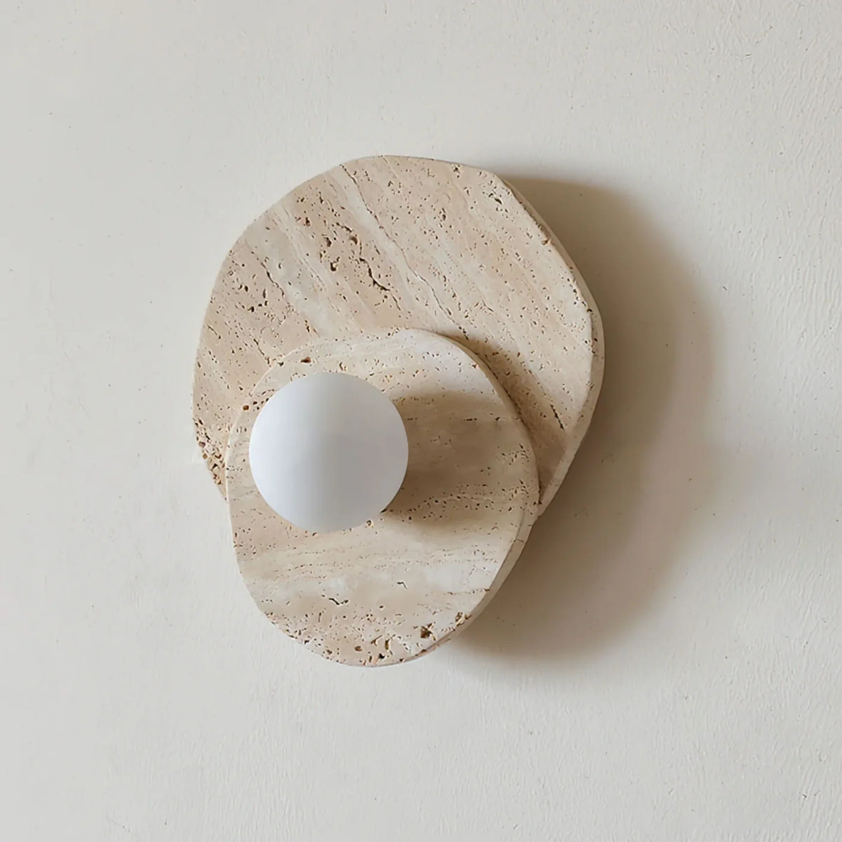 Abbot marble wall lamp with layered natural stone discs and an opal globe