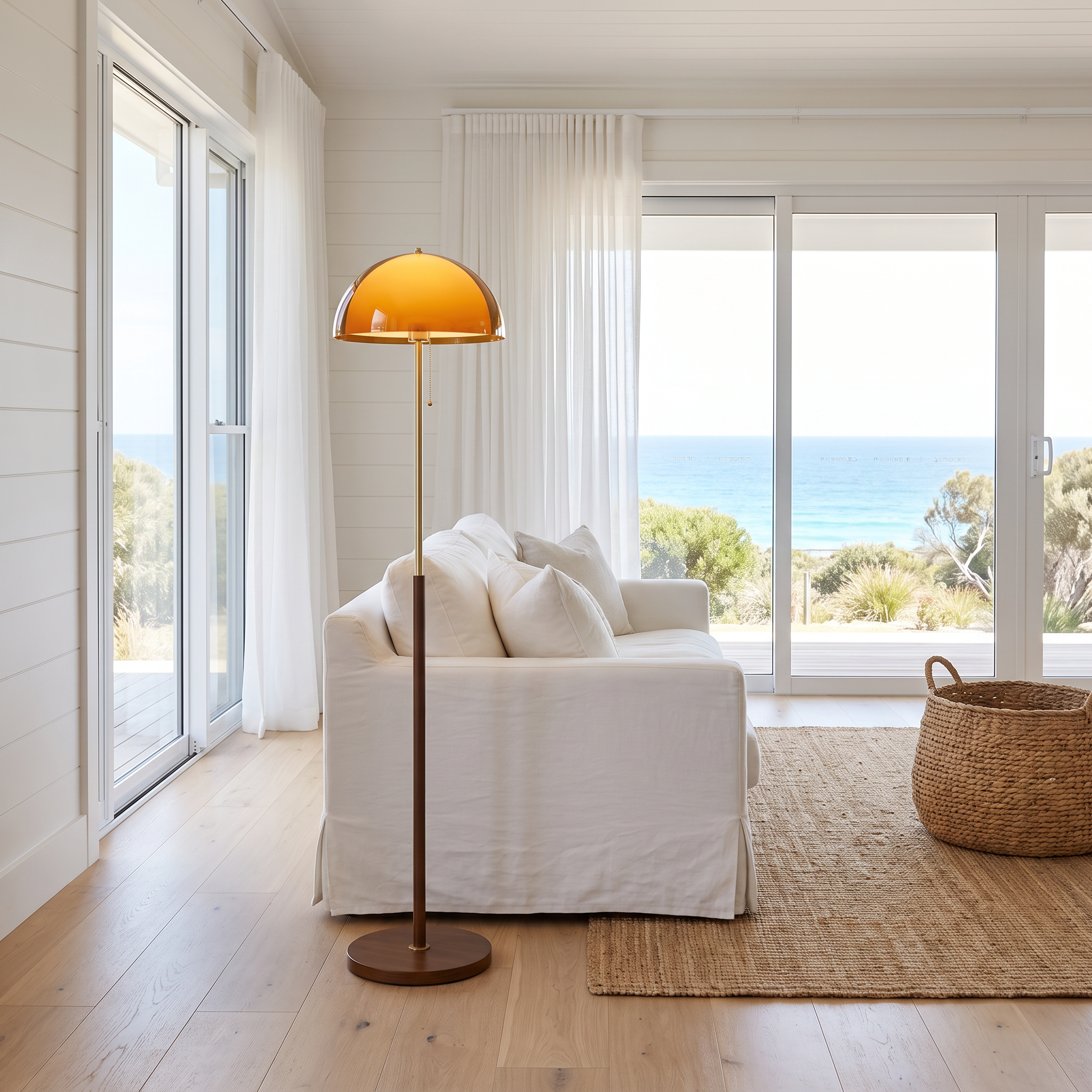 Caroline retro amber dome floor lamp in a bright beach house living room with ocean view