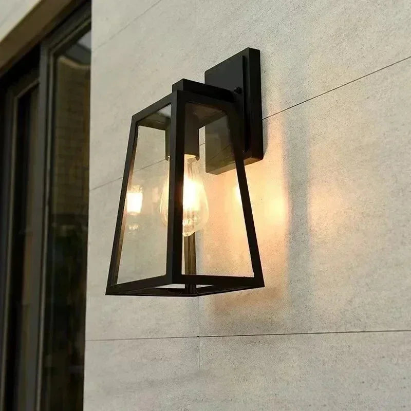 Axton Aluminium Outdoor Wall Lamp illuminated at night near a front entrance