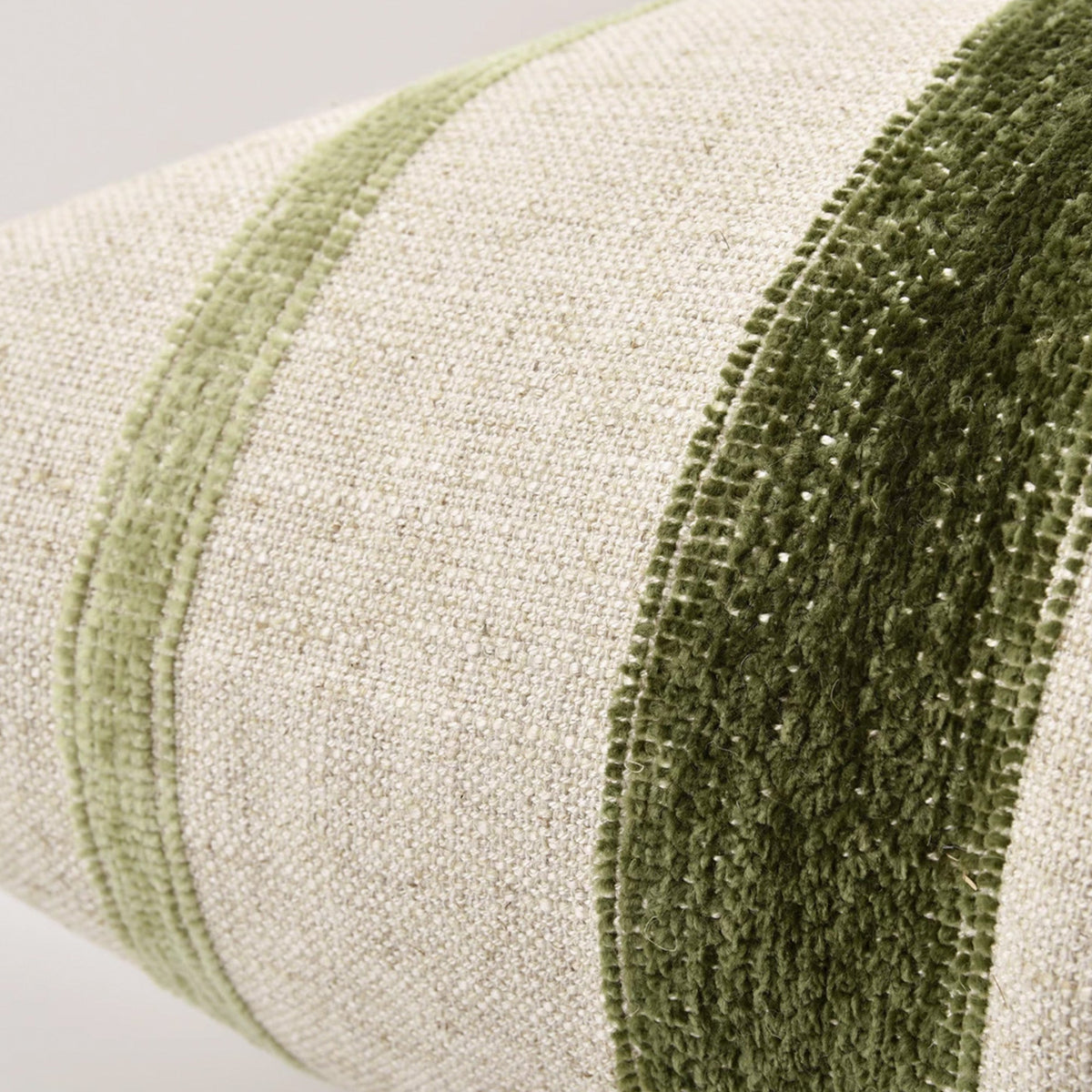 Close-up of the Banks throw pillow showing natural linen with green velvet and sage stripes