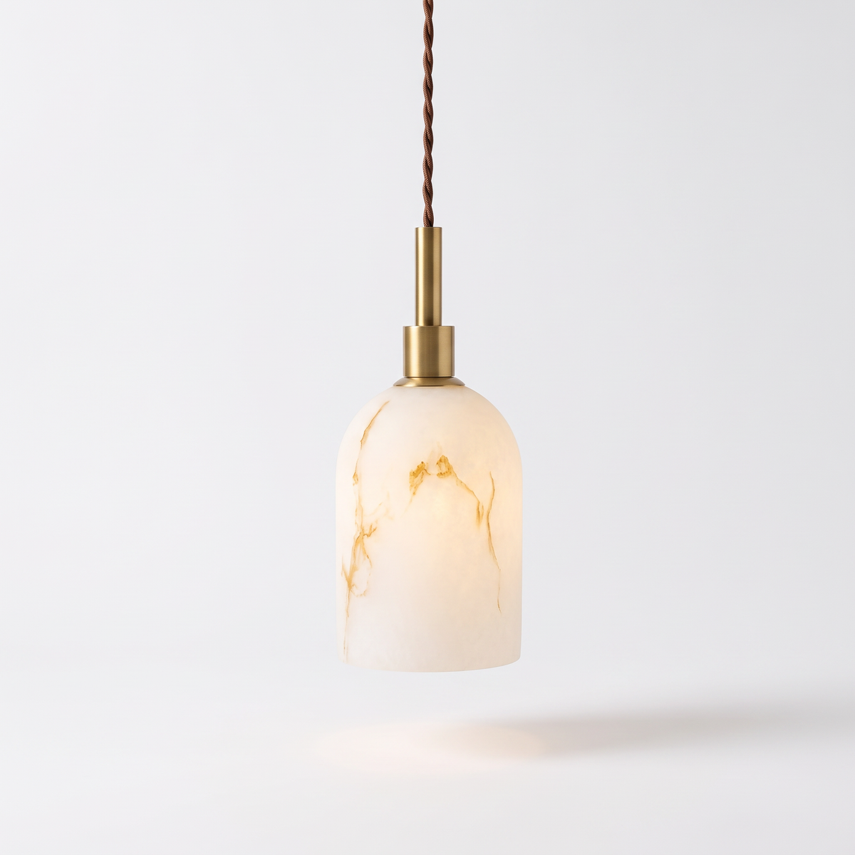 Banyjima Model A faux alabaster capsule pendant with a brass neck on a white background