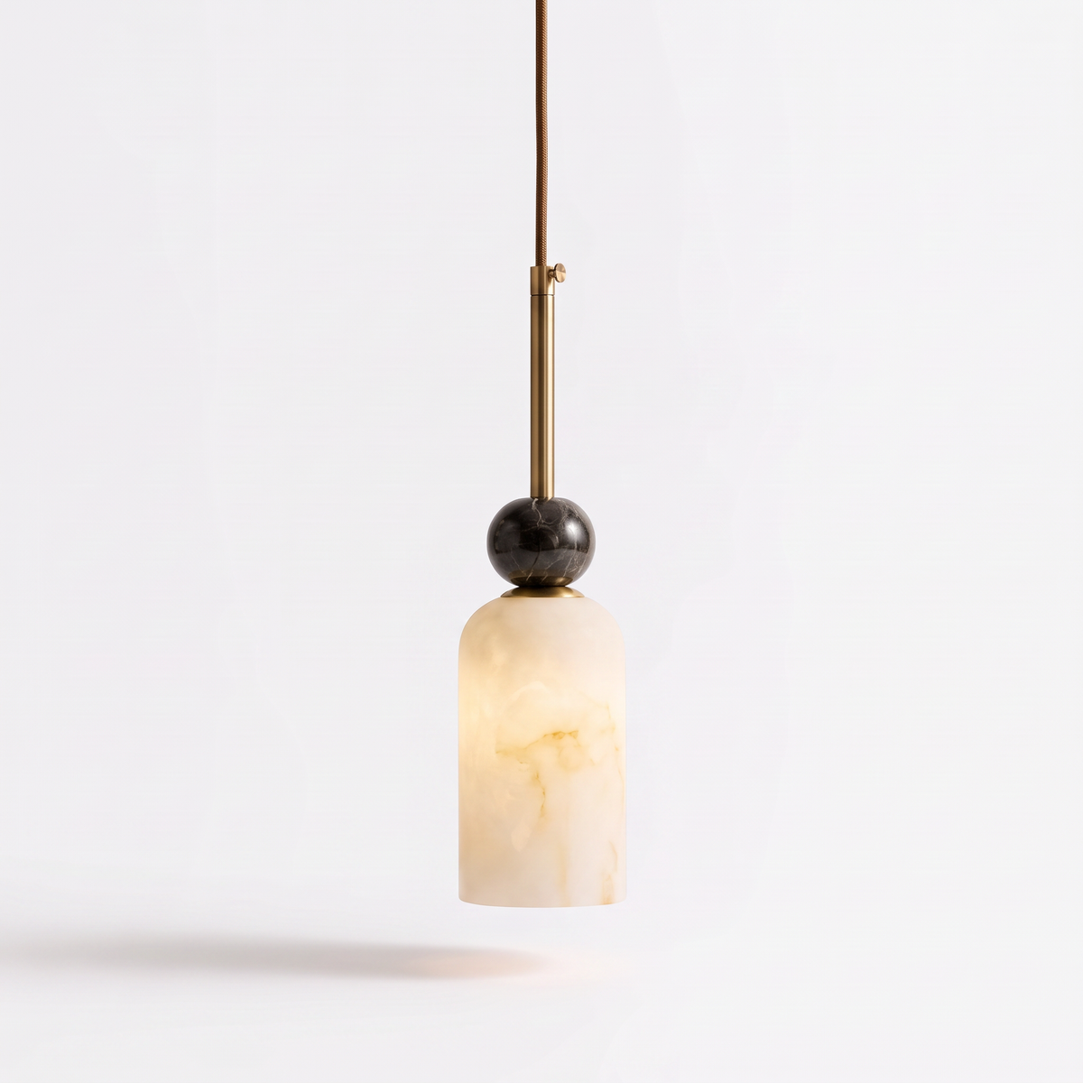 Banyjima Model C slim faux alabaster pendant with a dark marble ball on a white background