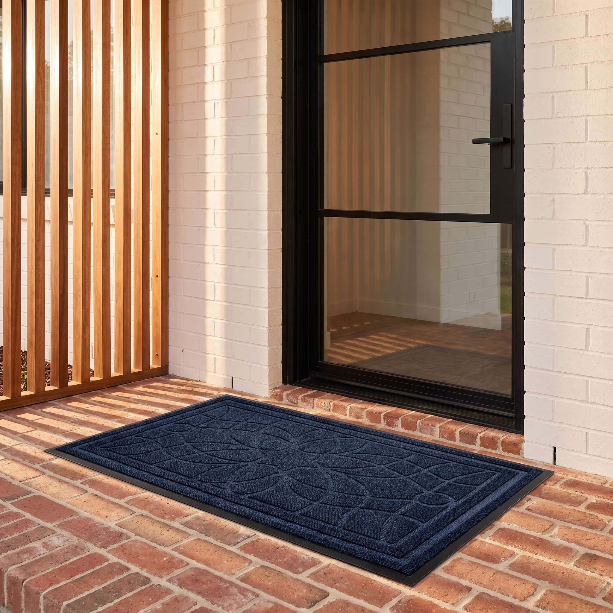 Bella mandala doormat in blue on a red brick front porch