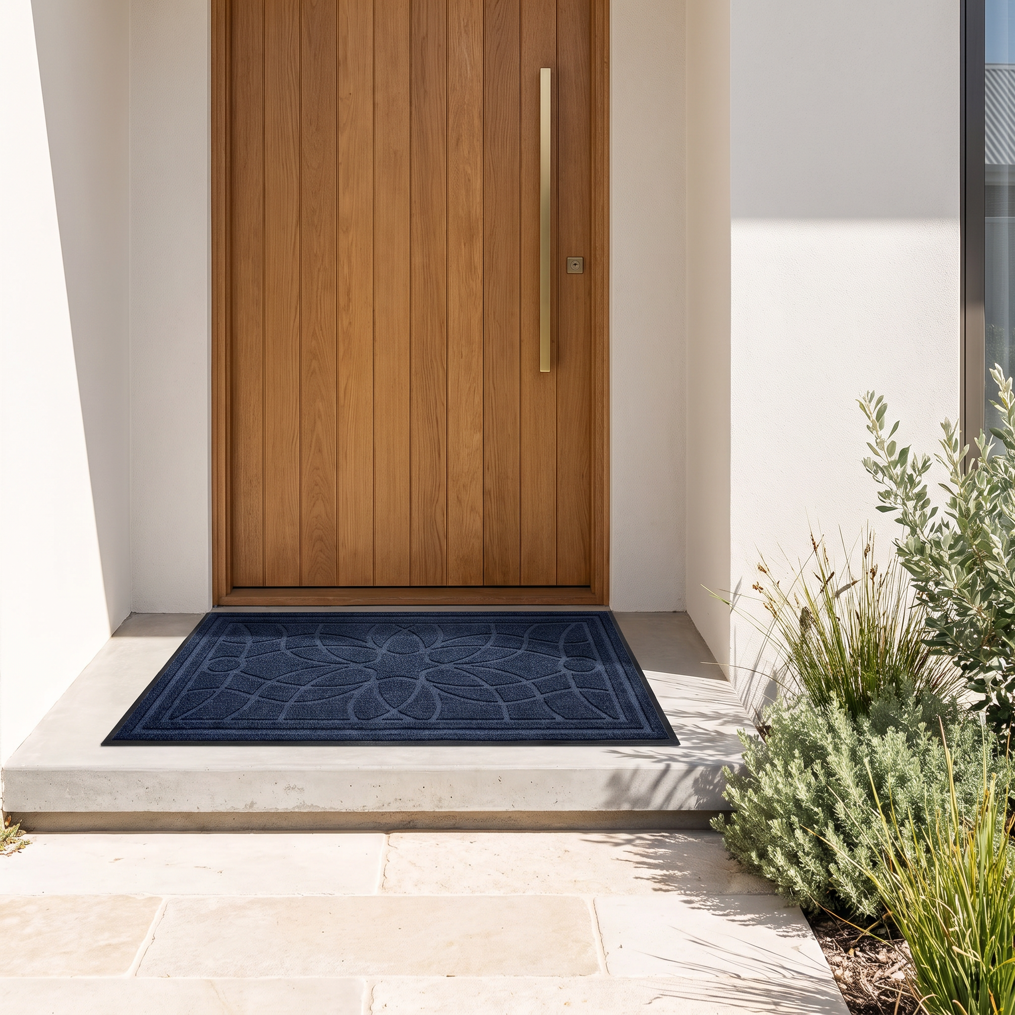 Bella mandala doormat in blue on a concrete step at an oak front door