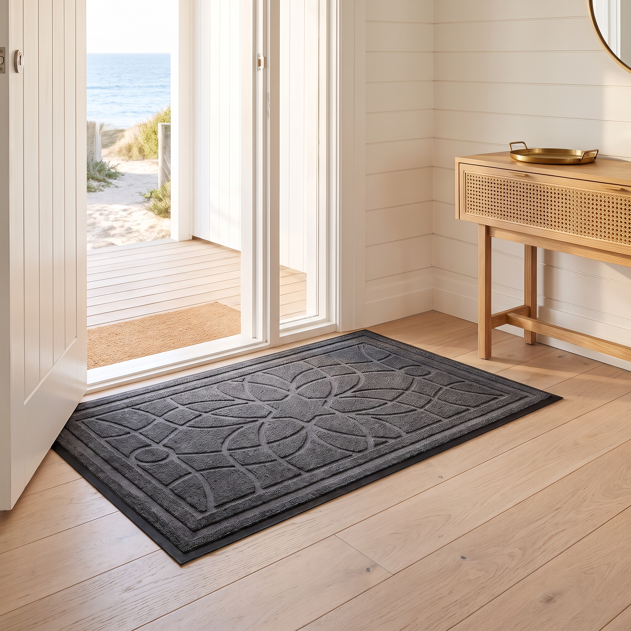 Bella mandala doormat in gray on oak floorboards at a beach house entry